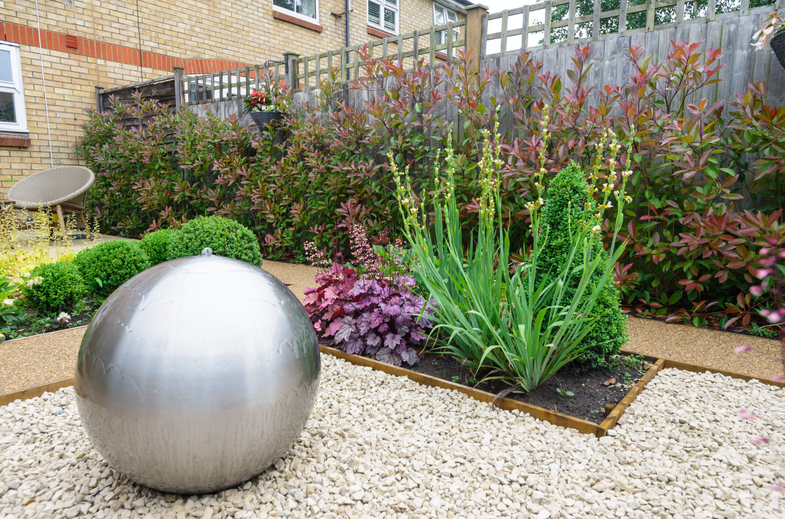Landscaped garden with silver globe fountain